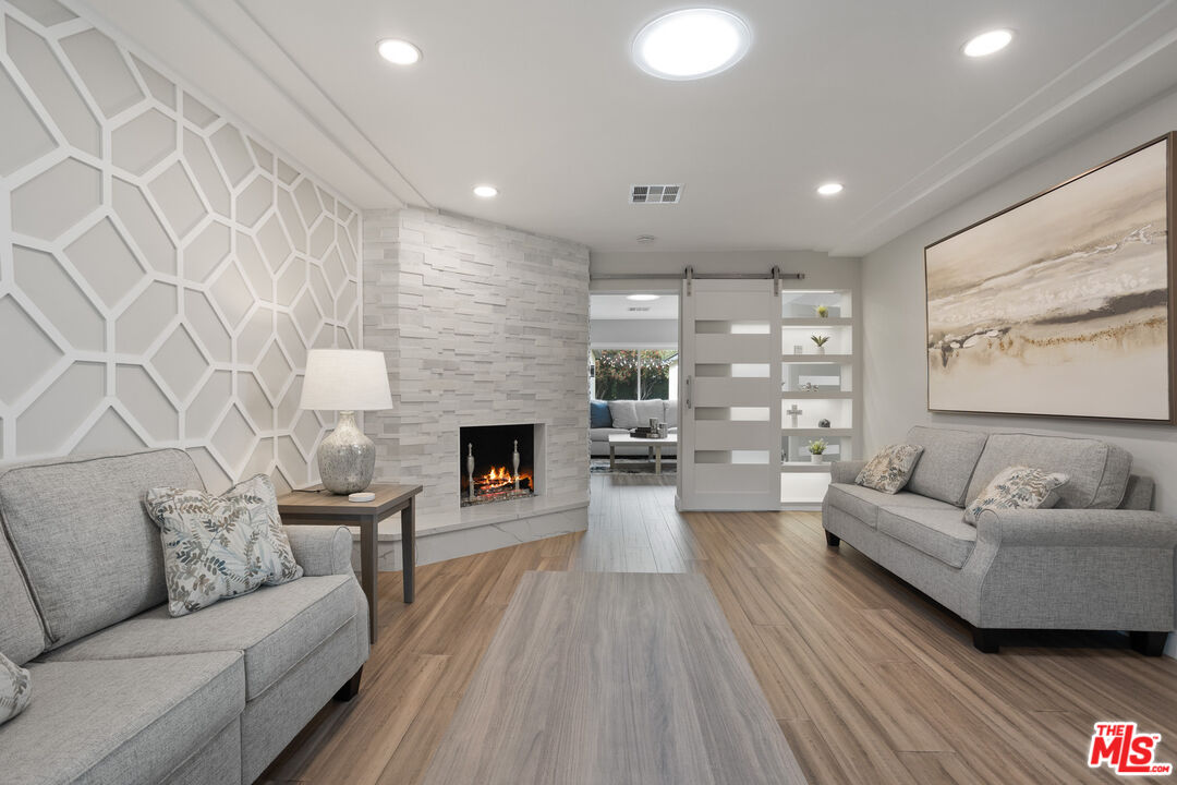 393 Allendale Road Pasadena, CA 91106 - Photo 10 of 75 a living room with furniture and a fireplace