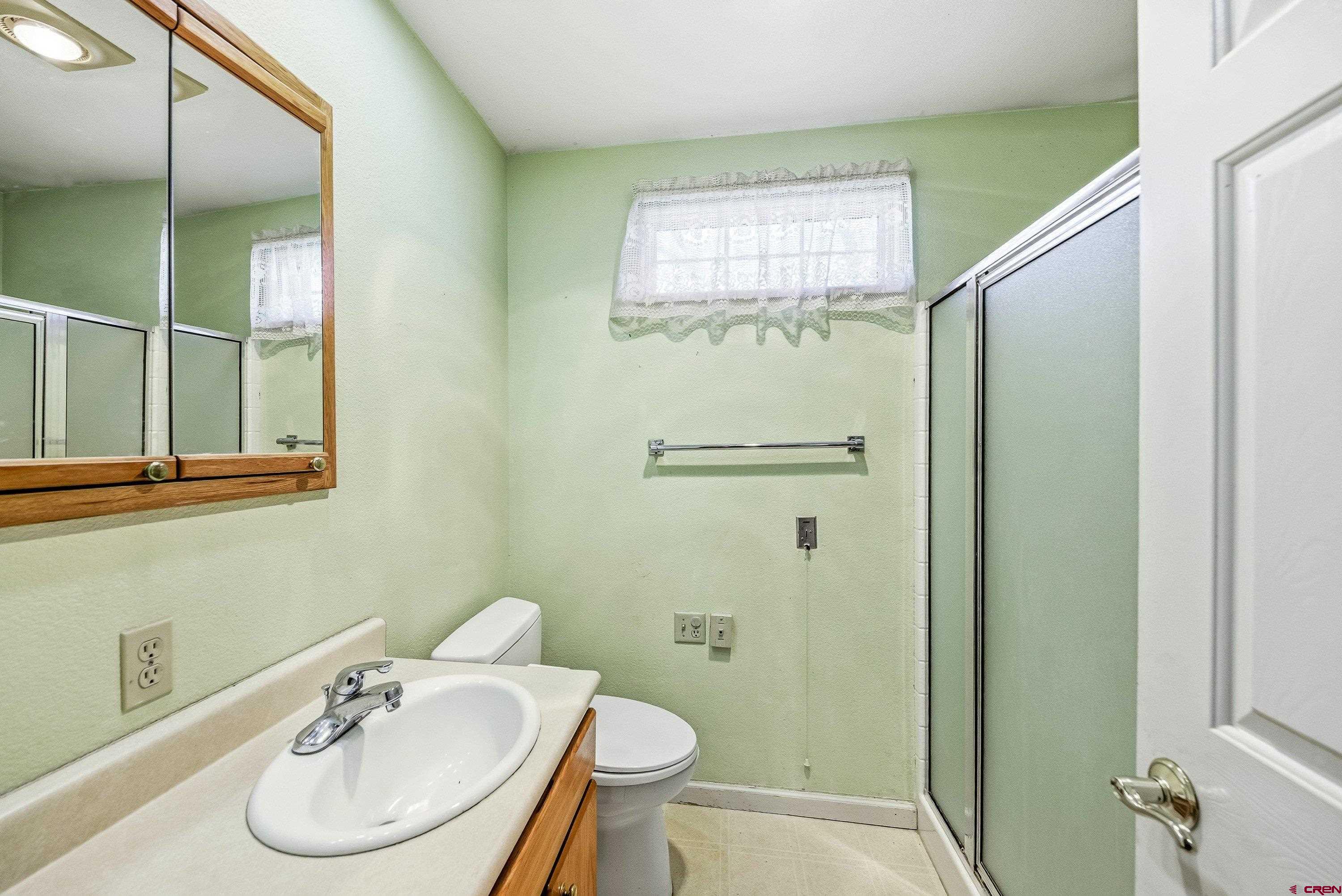 401 Grand Avenue, Unit B Delta, CO 81416 - Photo 11 of 14 a bathroom with a sink toilet and shower