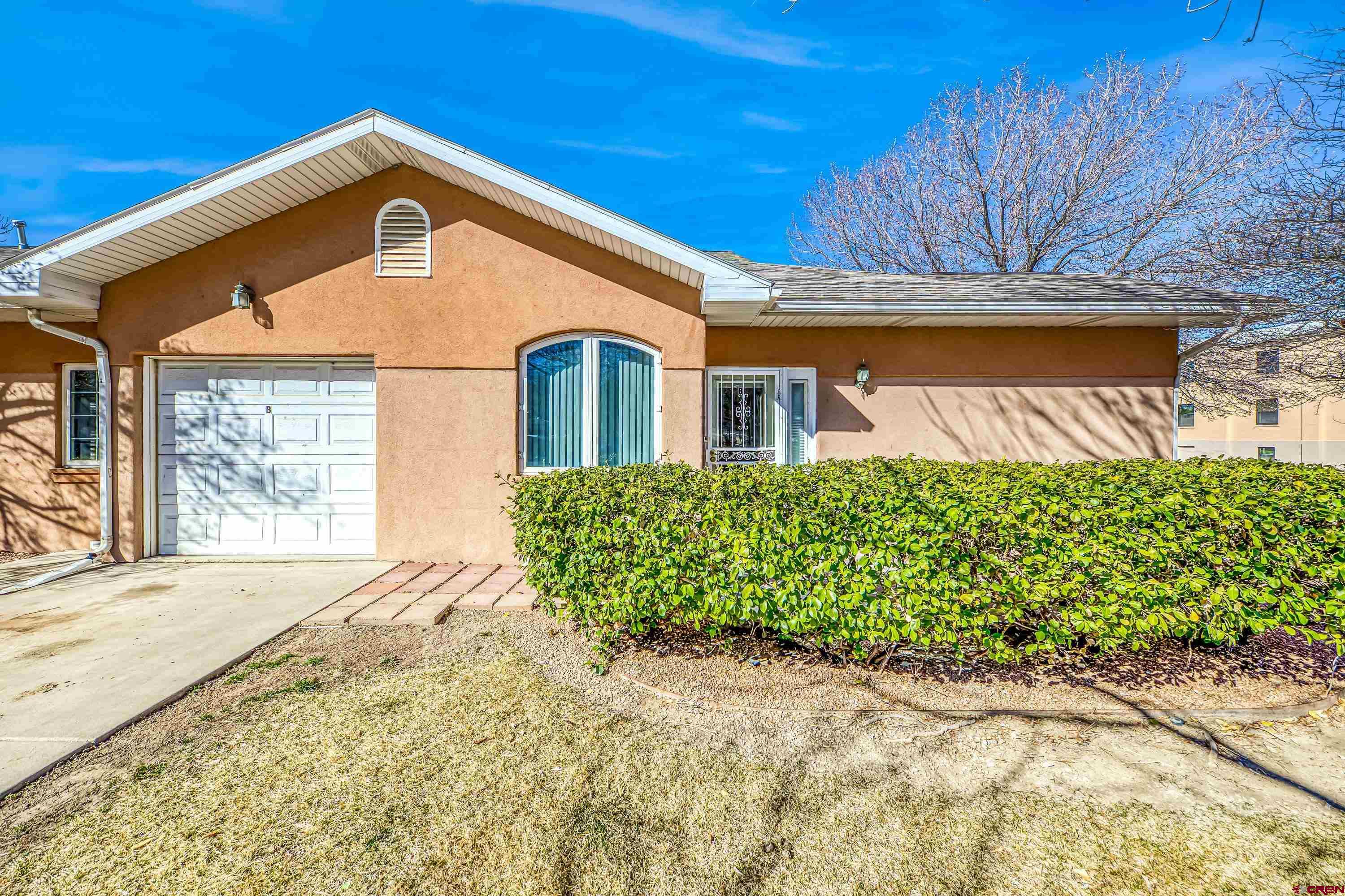 401 Grand Avenue, Unit B Delta, CO 81416 - Photo 14 of 14 a front view of a house with a yard