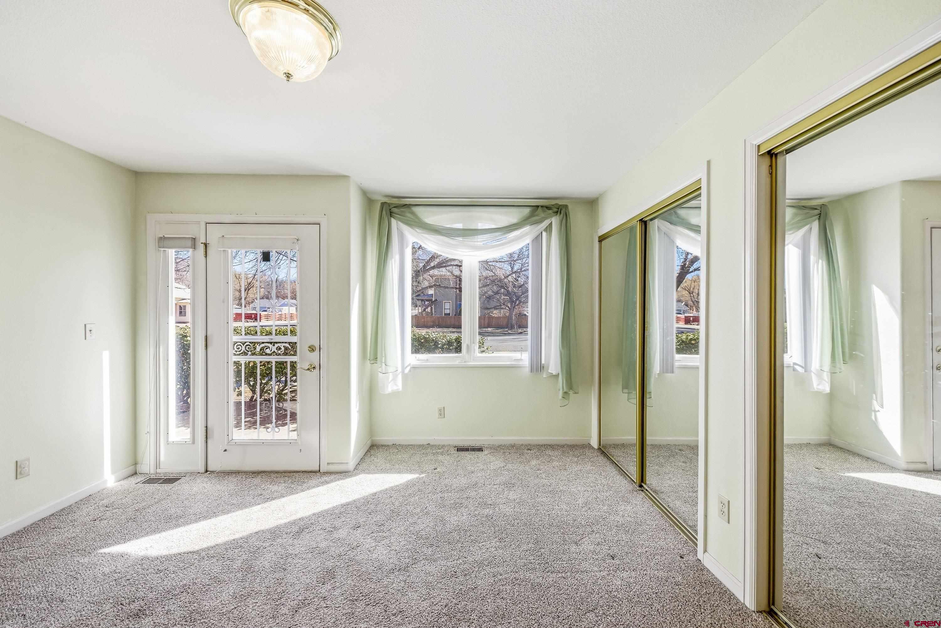 401 Grand Avenue, Unit B Delta, CO 81416 - Photo 3 of 14 an empty room with windows