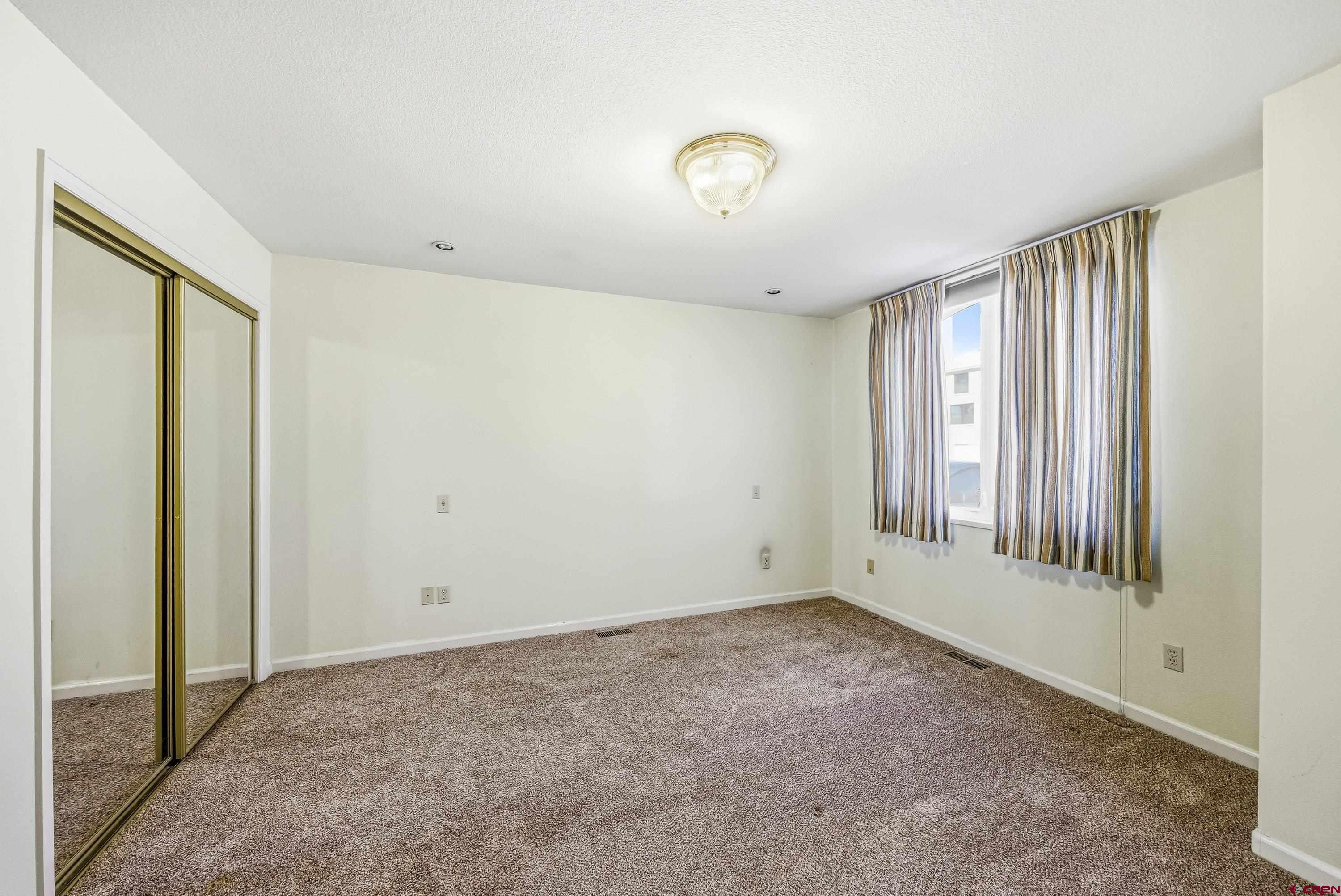 401 Grand Avenue, Unit B Delta, CO 81416 - Photo 8 of 14 a view of an empty room with a window