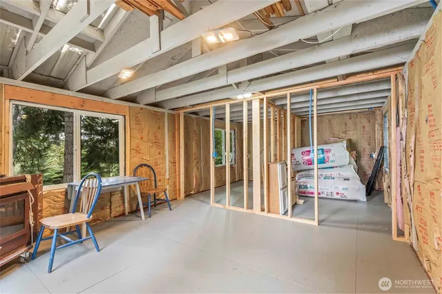 a view of a patio with table and chairs and floor to ceiling window