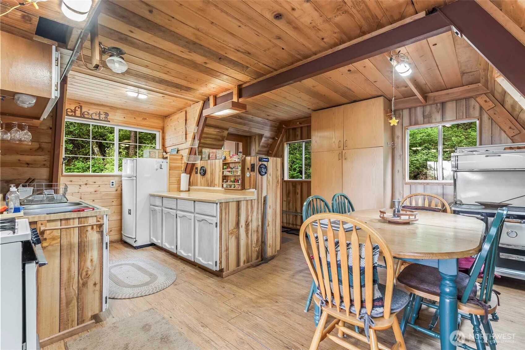 181 Elk Road Cle Elum, WA 98922 - Photo 7 of 31 a dining room with furniture wooden floor and a floor to ceiling window
