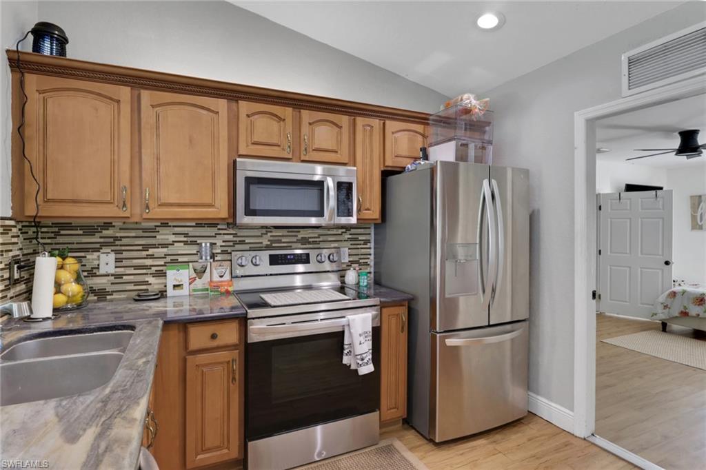 3341 2nd Avenue Southeast Naples, FL 34117 - Photo 12 of 43 a kitchen with a refrigerator sink and microwave