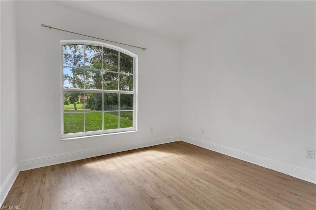 3341 2nd Avenue Southeast Naples, FL 34117 - Photo 22 of 43 an empty room with wooden floor and windows