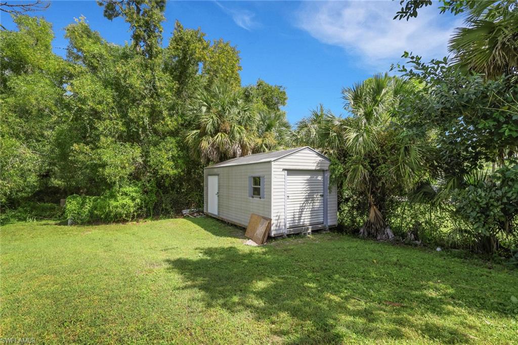3341 2nd Avenue Southeast Naples, FL 34117 - Photo 24 of 43 a view of a backyard with potted plants and large trees
