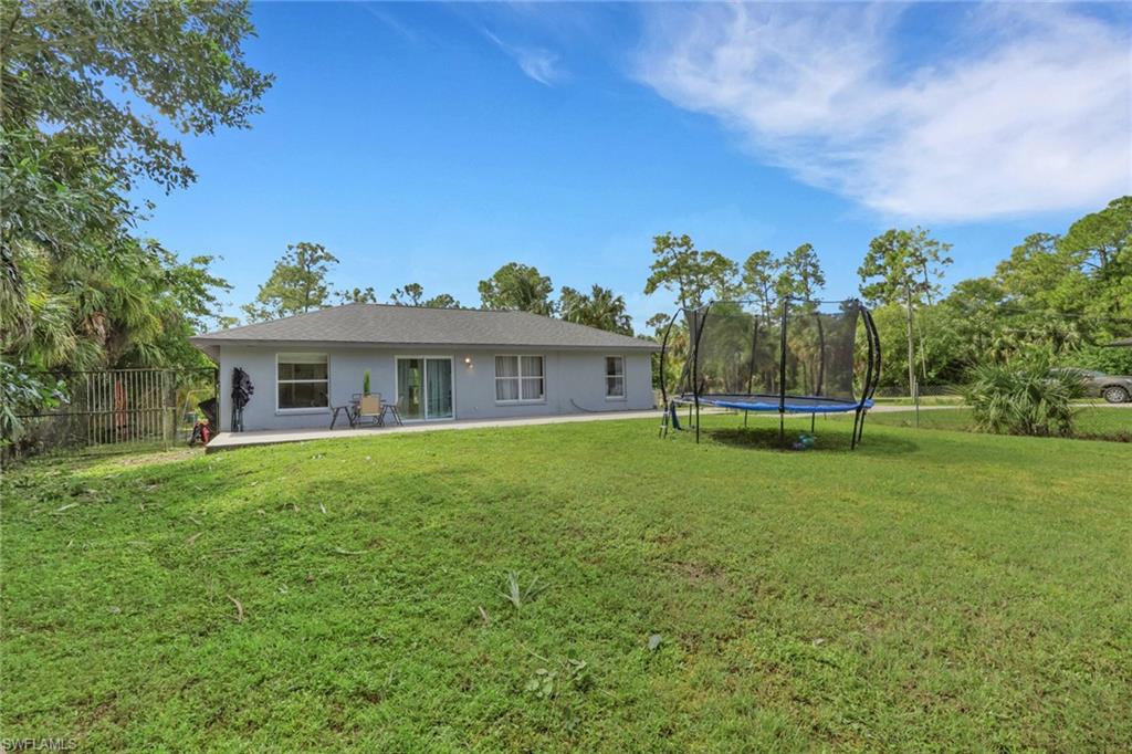 3341 2nd Avenue Southeast Naples, FL 34117 - Photo 25 of 43 a front view of house with outdoor seating and green space