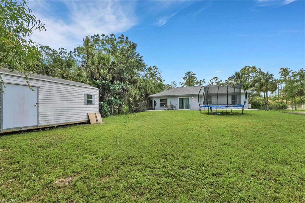 3341 2nd Avenue Southeast Naples, FL 34117 - Photo 26 of 43 a front view of a house with a garden