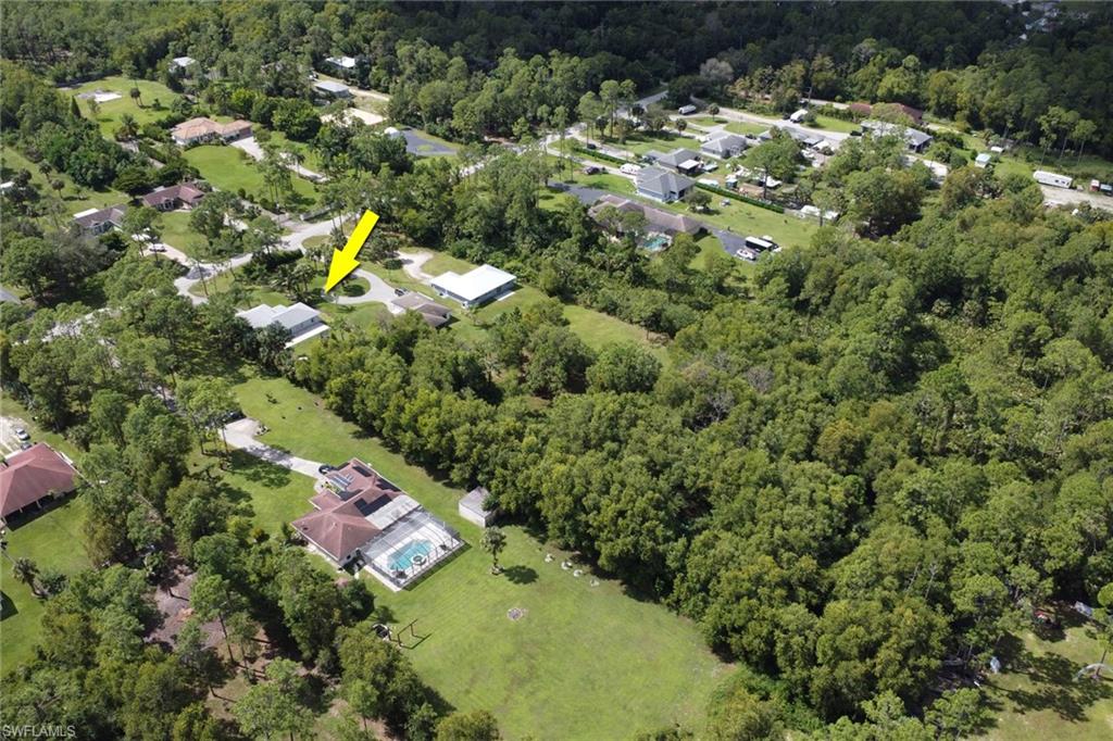 3341 2nd Avenue Southeast Naples, FL 34117 - Photo 29 of 43 a view of a houses with a lush green forest