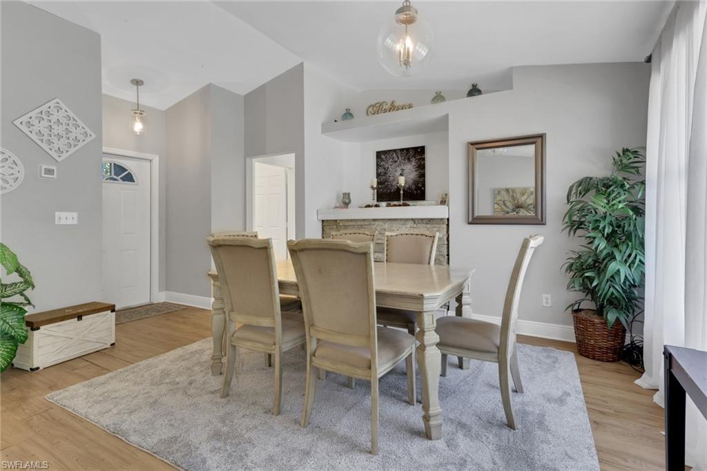 3341 2nd Avenue Southeast Naples, FL 34117 - Photo 6 of 43 a view of a dining room with furniture and wooden floor