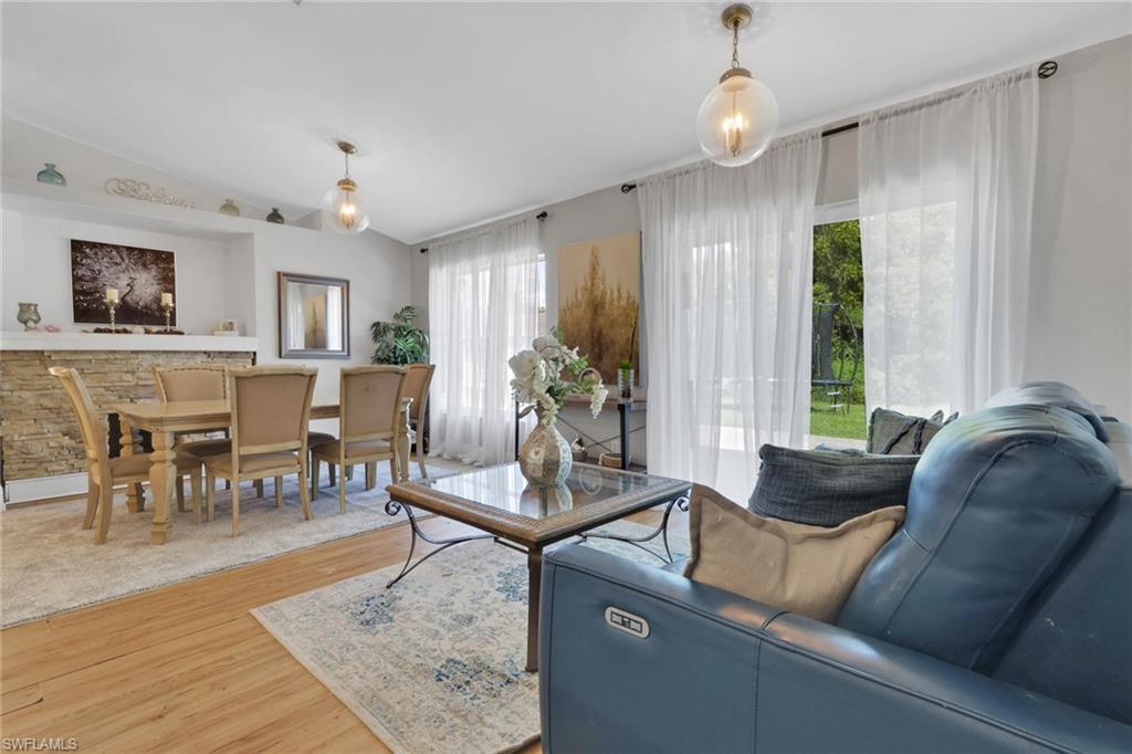 3341 2nd Avenue Southeast Naples, FL 34117 - Photo 9 of 43 a living room with furniture and a window
