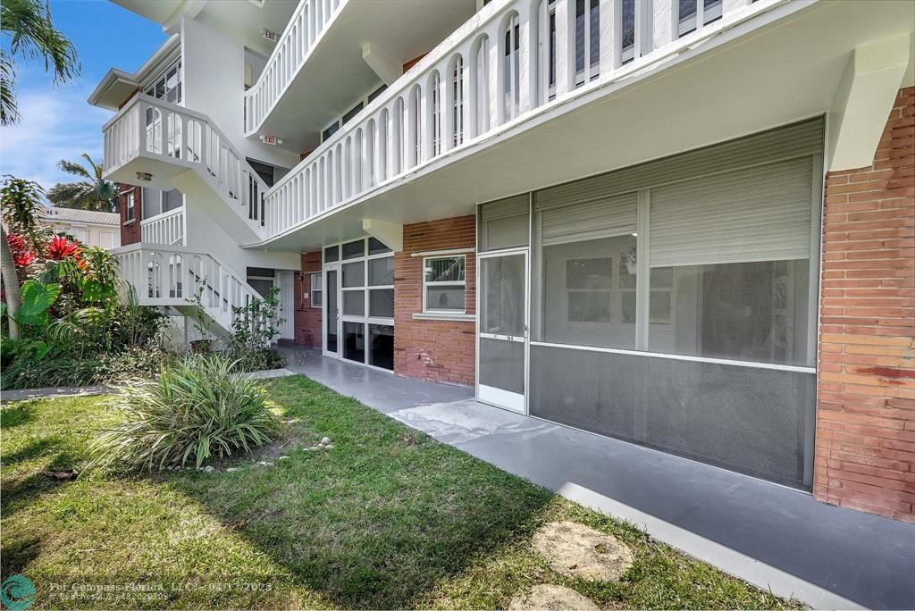 a house with lots of trees in front of it
