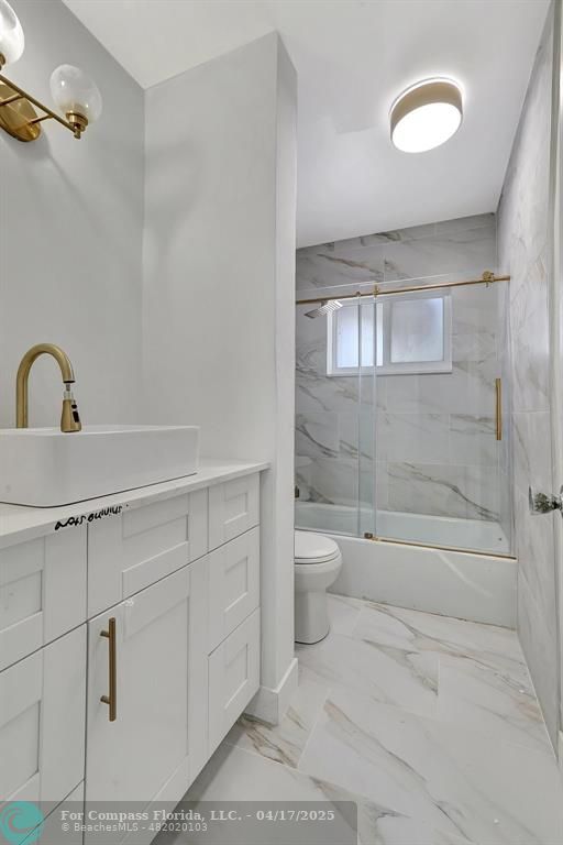 161 Northeast 10th Avenue, Unit 14A Hallandale Beach, FL 33009 - Photo 11 of 45 a bathroom with a shower a toilet and a sink