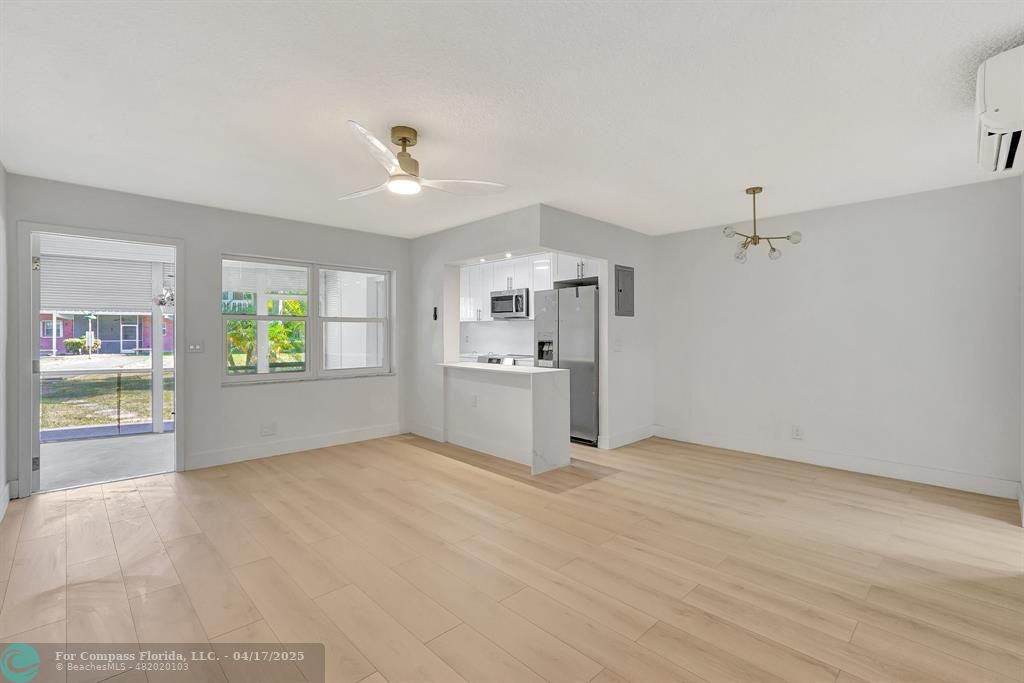 161 Northeast 10th Avenue, Unit 14A Hallandale Beach, FL 33009 - Photo 15 of 45 an empty room with windows and entrance