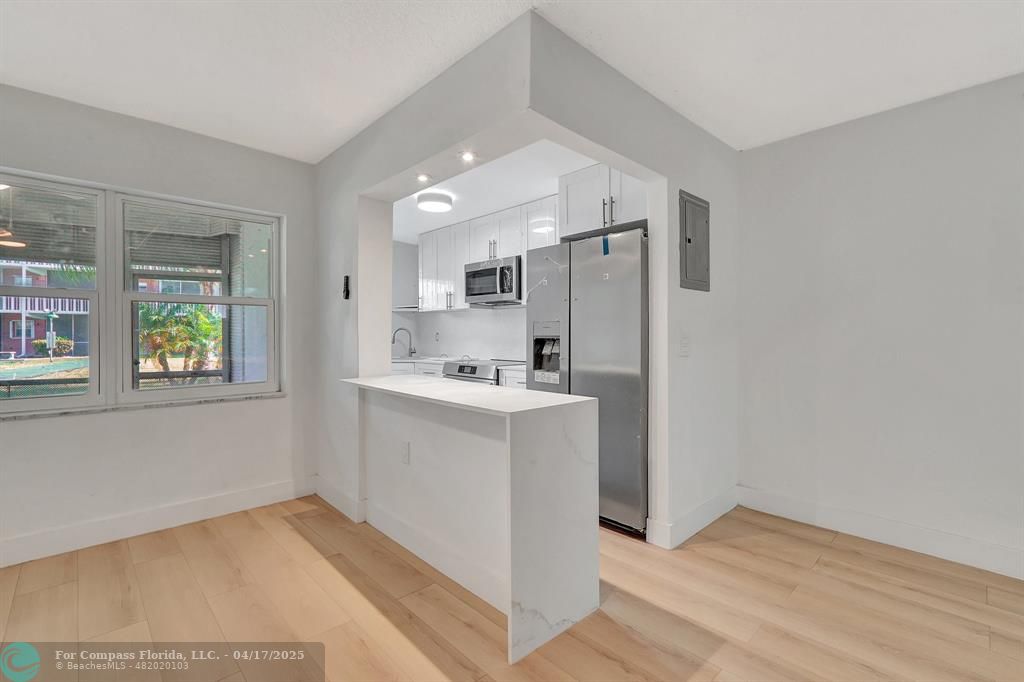 161 Northeast 10th Avenue, Unit 14A Hallandale Beach, FL 33009 - Photo 17 of 45 a view of kitchen with sink and refrigerator