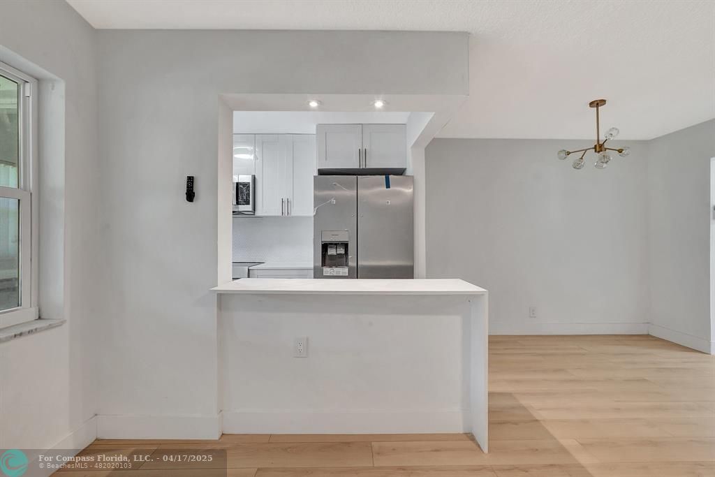 161 Northeast 10th Avenue, Unit 14A Hallandale Beach, FL 33009 - Photo 18 of 45 a view of kitchen with stainless steel appliances granite countertop cabinets and wooden floor