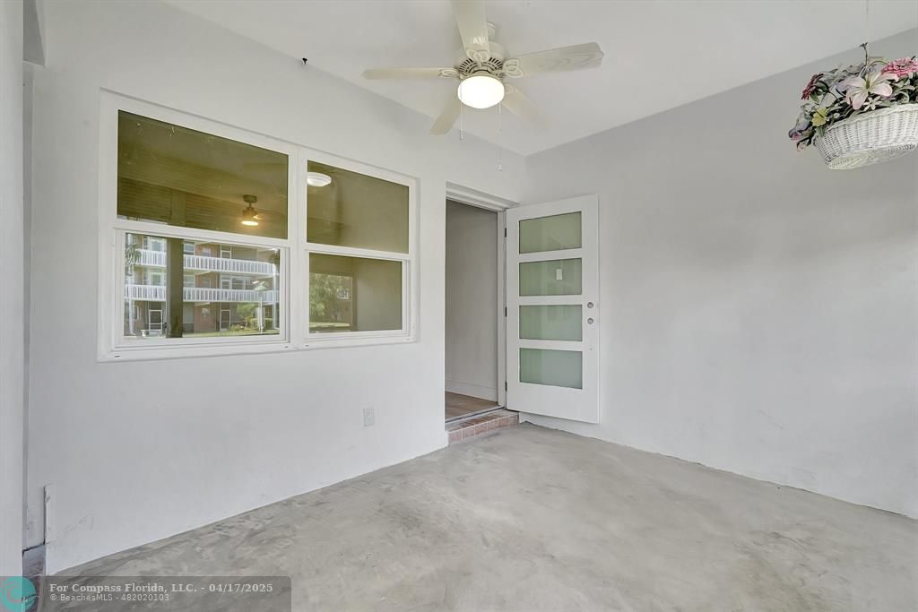 161 Northeast 10th Avenue, Unit 14A Hallandale Beach, FL 33009 - Photo 24 of 45 an empty room with a window and fireplace