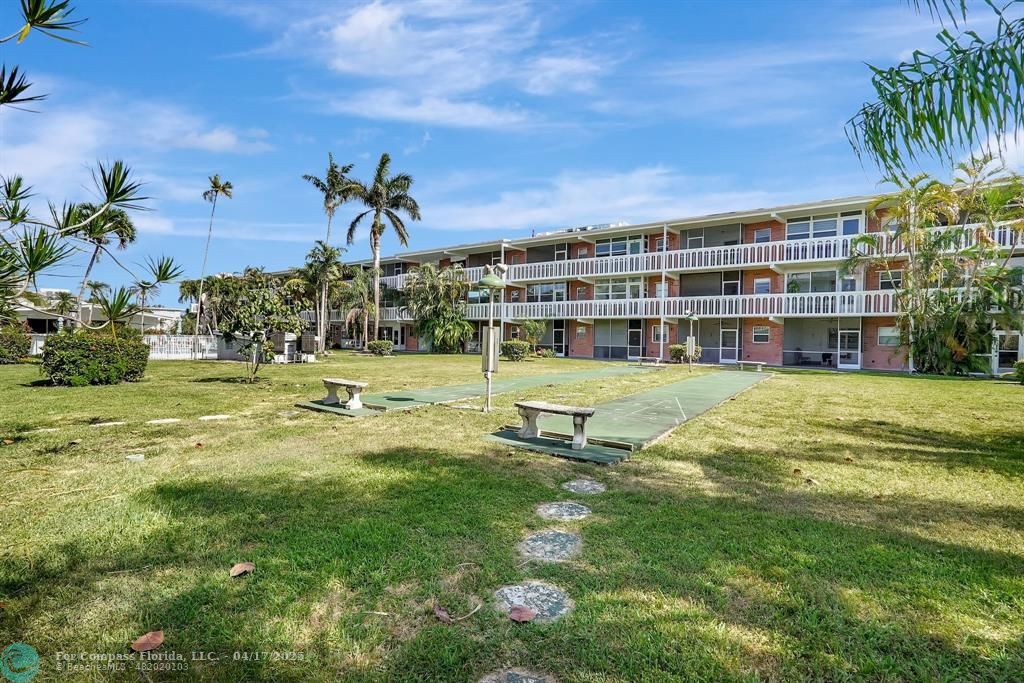 161 Northeast 10th Avenue, Unit 14A Hallandale Beach, FL 33009 - Photo 25 of 45 a view of building with yard