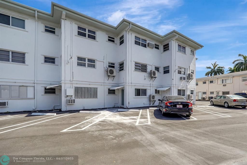 161 Northeast 10th Avenue, Unit 14A Hallandale Beach, FL 33009 - Photo 26 of 45 a view of car parked in front of building