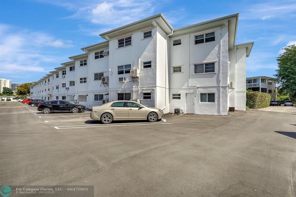 161 Northeast 10th Avenue, Unit 14A Hallandale Beach, FL 33009 - Photo 27 of 45 a view of a city street with tall buildings