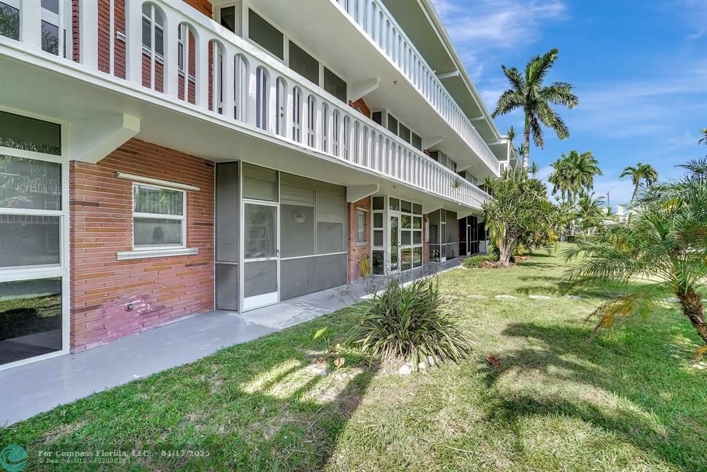 161 Northeast 10th Avenue, Unit 14A Hallandale Beach, FL 33009 - Photo 3 of 45 a front view of a house with a yard