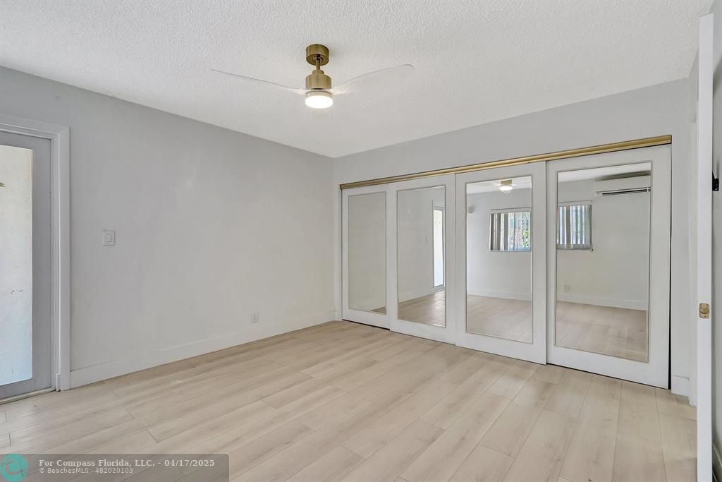 161 Northeast 10th Avenue, Unit 14A Hallandale Beach, FL 33009 - Photo 6 of 45 a view of an empty room with window