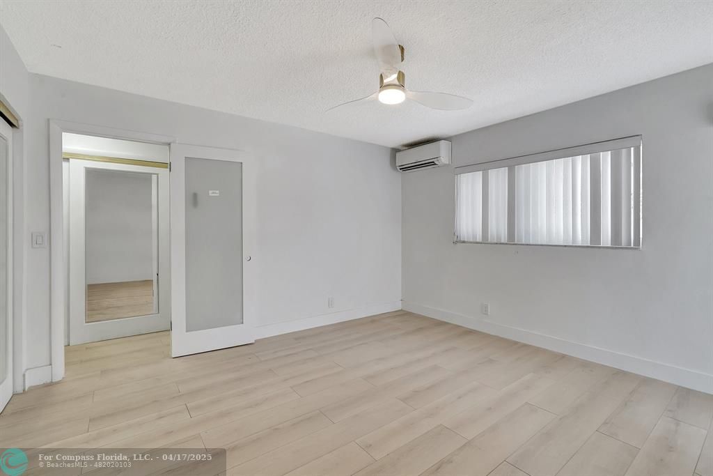 161 Northeast 10th Avenue, Unit 14A Hallandale Beach, FL 33009 - Photo 8 of 45 a view of an empty room with a window
