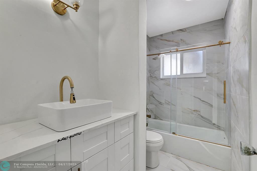 161 Northeast 10th Avenue, Unit 14A Hallandale Beach, FL 33009 - Photo 10 of 45 a bathroom with a sink a toilet and shower