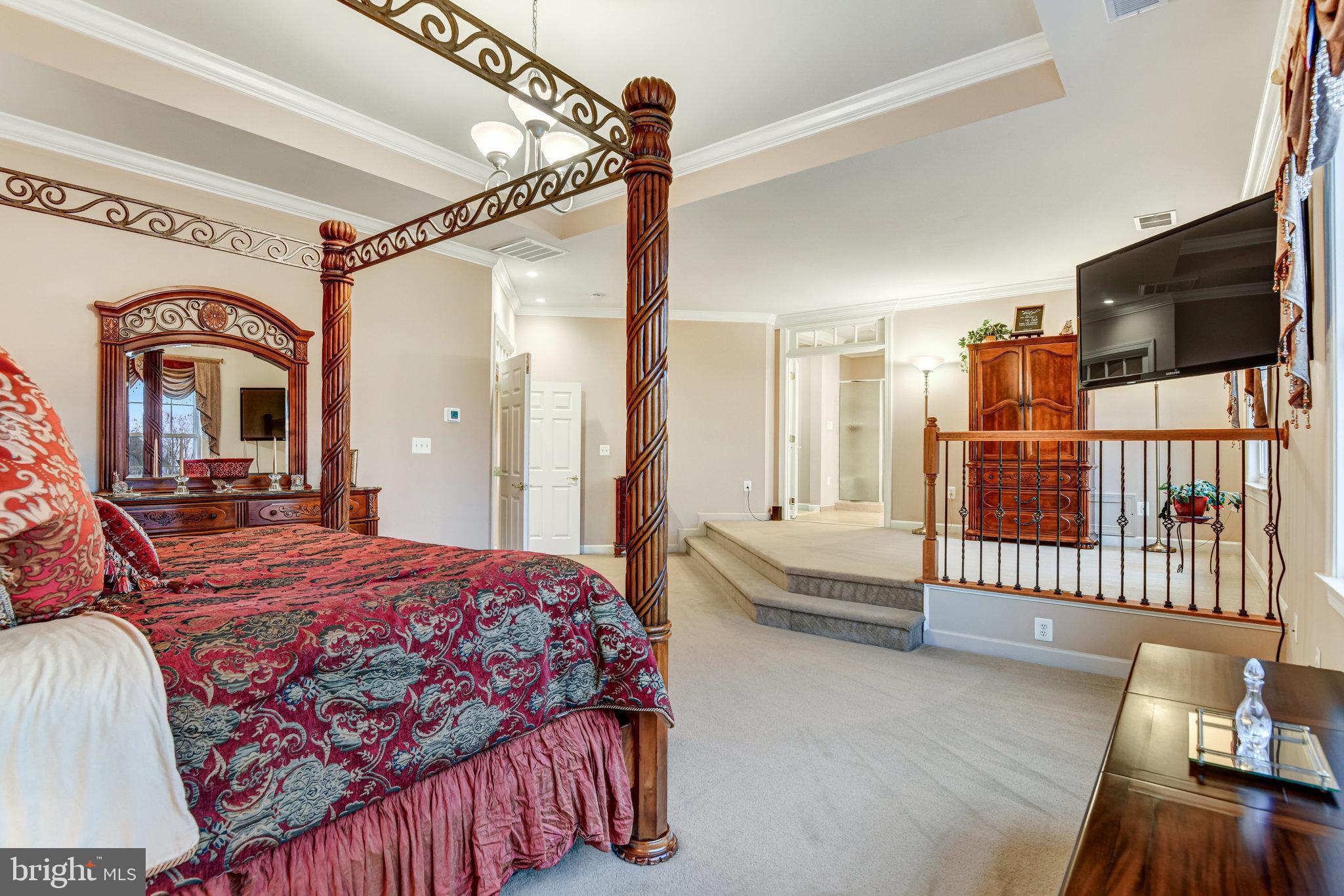 24958 Brookbark Terrace Chantilly, VA 20152 - Photo 16 of 26 a bedroom with a bed a flat screen tv and dresser