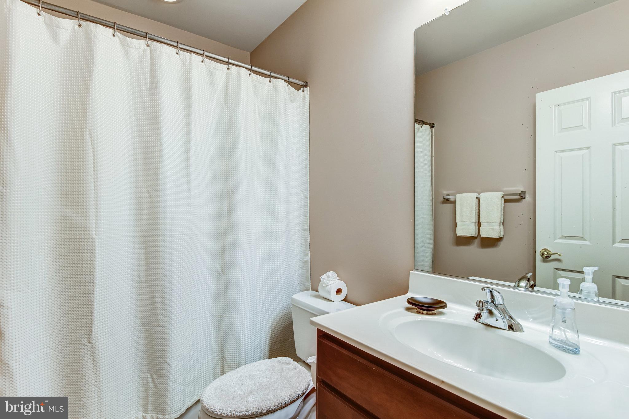24958 Brookbark Terrace Chantilly, VA 20152 - Photo 17 of 26 a bathroom with a sink and a mirror