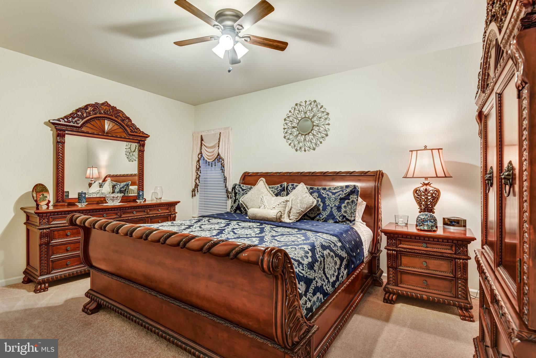 24958 Brookbark Terrace Chantilly, VA 20152 - Photo 23 of 26 a bedroom with a bed and a chandelier