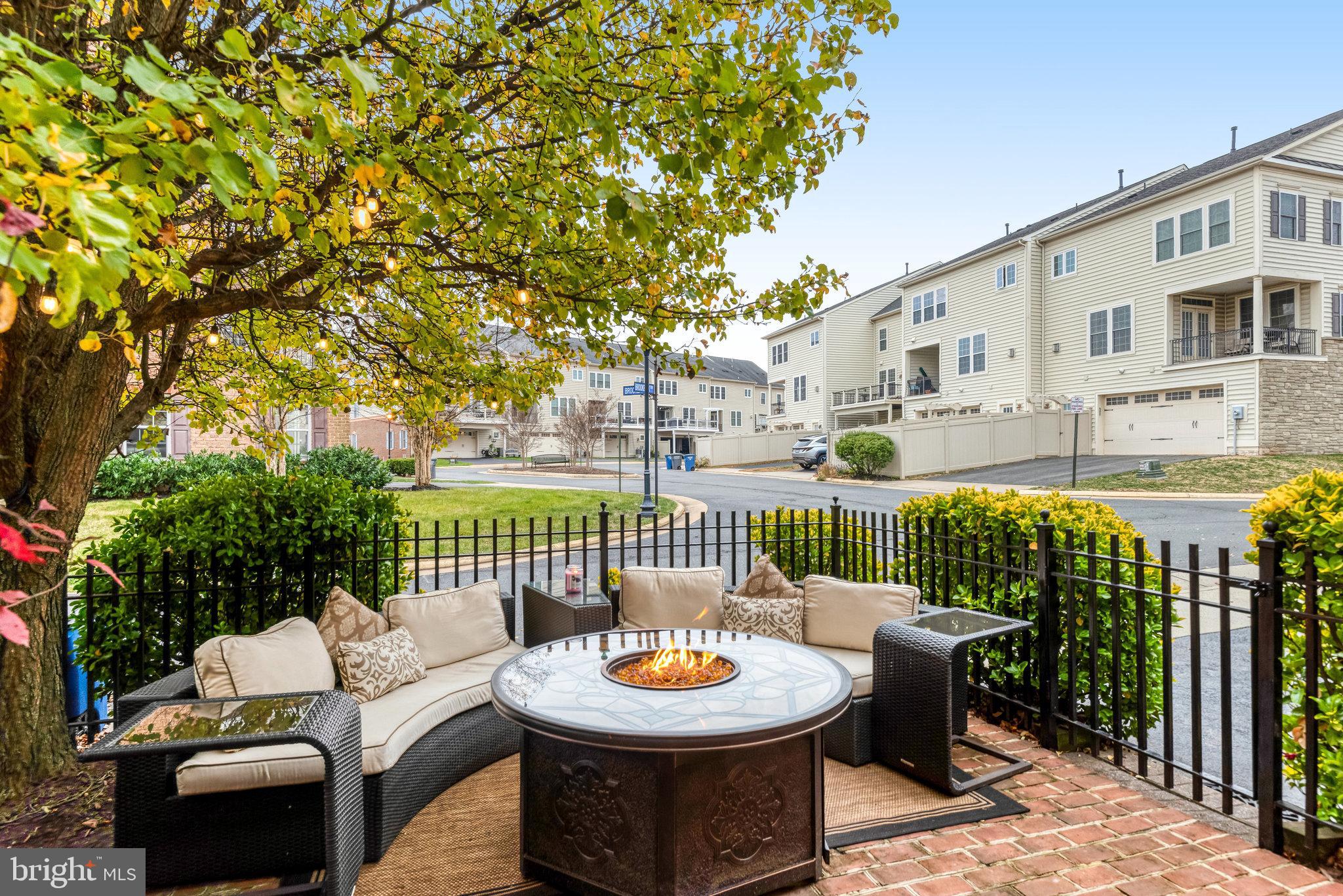 24958 Brookbark Terrace Chantilly, VA 20152 - Photo 4 of 26 a view of a patio with a dining table and chairs with a small yard