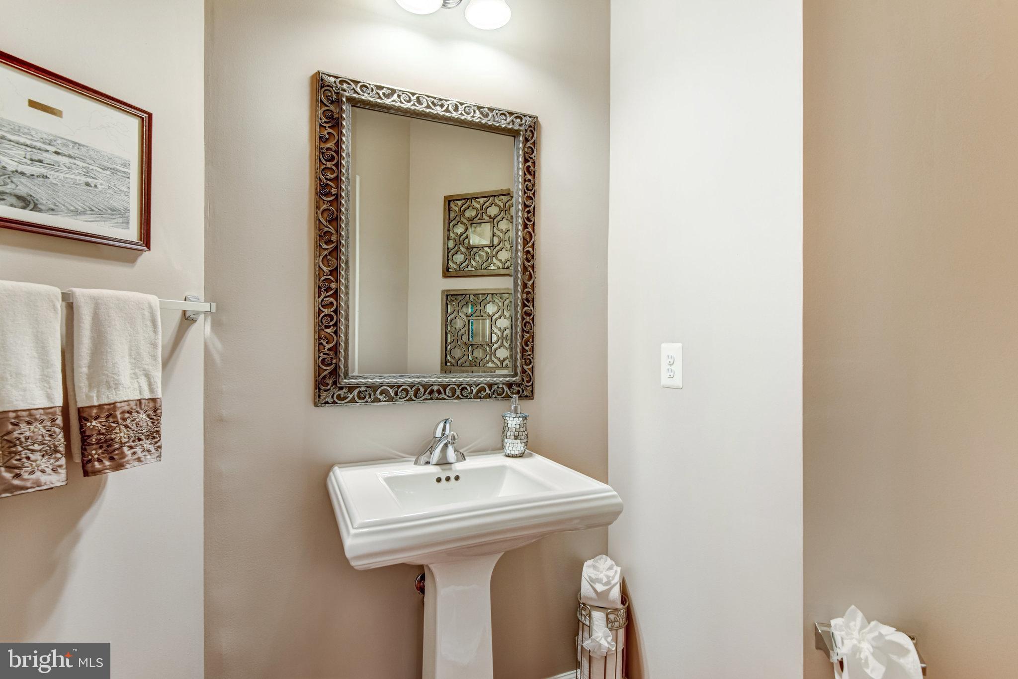 24958 Brookbark Terrace Chantilly, VA 20152 - Photo 10 of 26 a bathroom with a sink and a mirror
