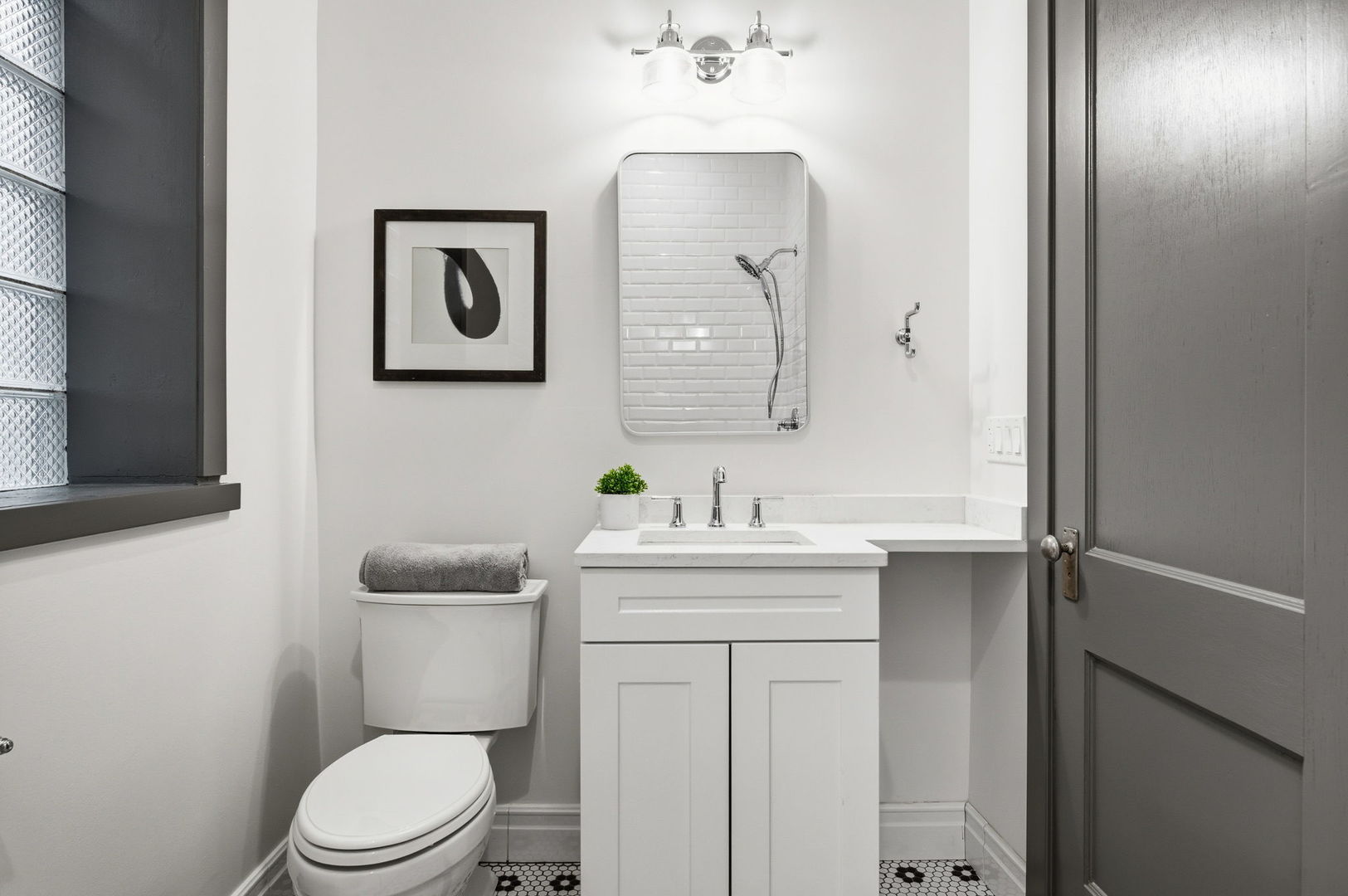 2920 West Altgeld Street, Unit 2 Chicago, IL 60647 - Photo 18 of 22 a bathroom with a toilet a sink a vanity and mirror