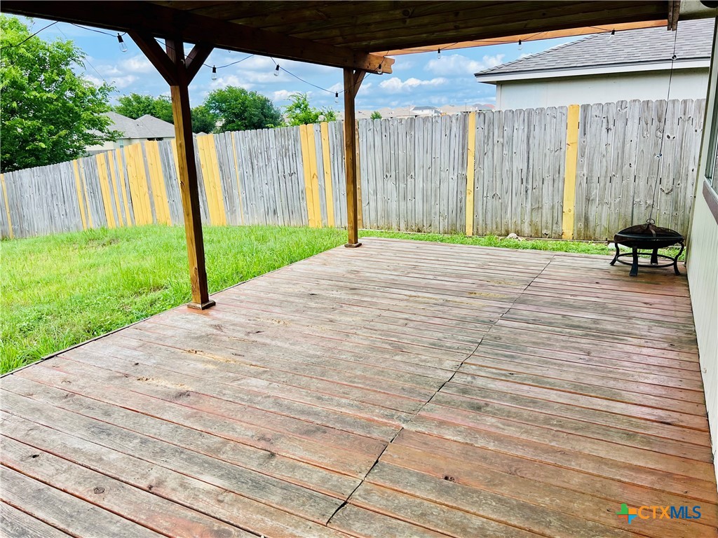 8210 Sunset Trail Temple, TX 76502 - Photo 14 of 15 a view of a backyard with table and chairs and wooden fence