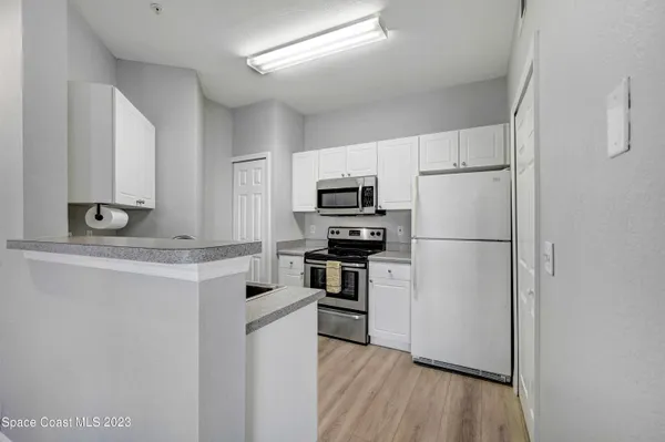 a kitchen with a refrigerator a stove top oven a sink and dishwasher