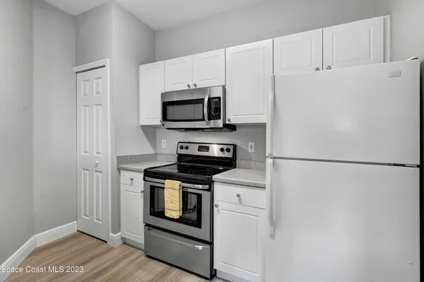 a kitchen with a refrigerator stove and microwave