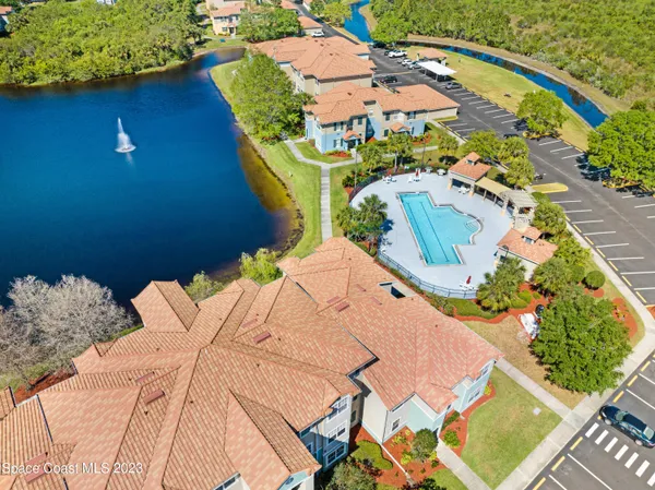an aerial view of a house with a swimming pool yard and outdoor seating