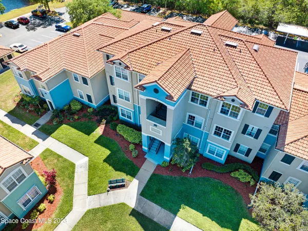 an aerial view of a house with a yard