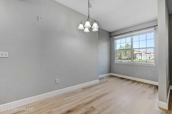a view of wooden floor and chandelier in a room