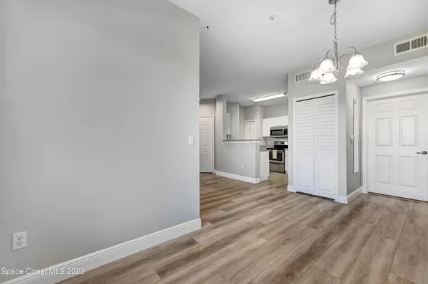 a view of a kitchen with wooden floor and a large window