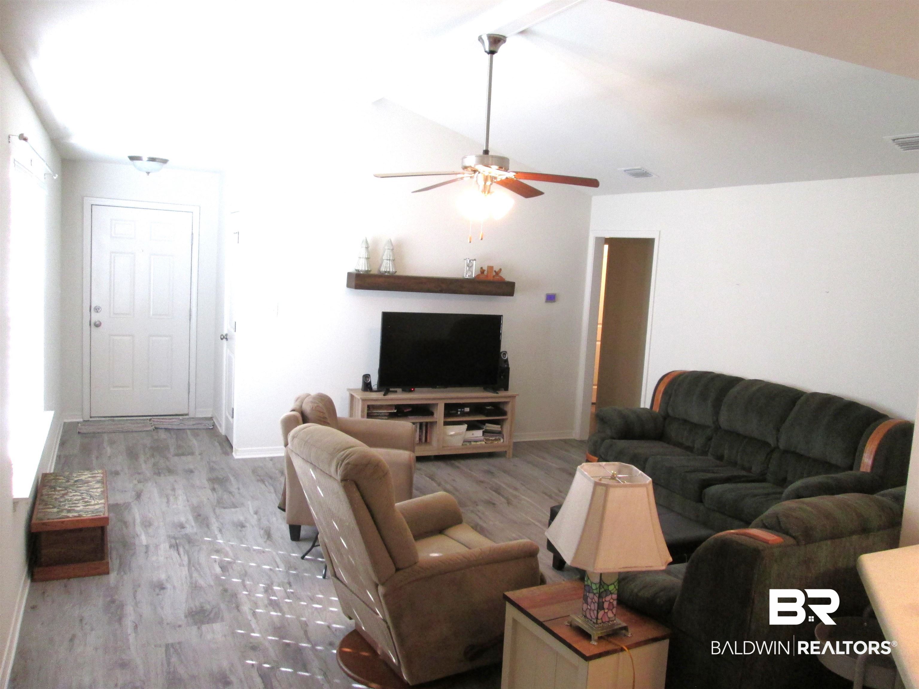 530 Brethren Church Road Fruitdale, AL 36539 - Photo 3 of 24 Living room with ceiling fan, light hardwood / wood-style floors, and lofted ceiling