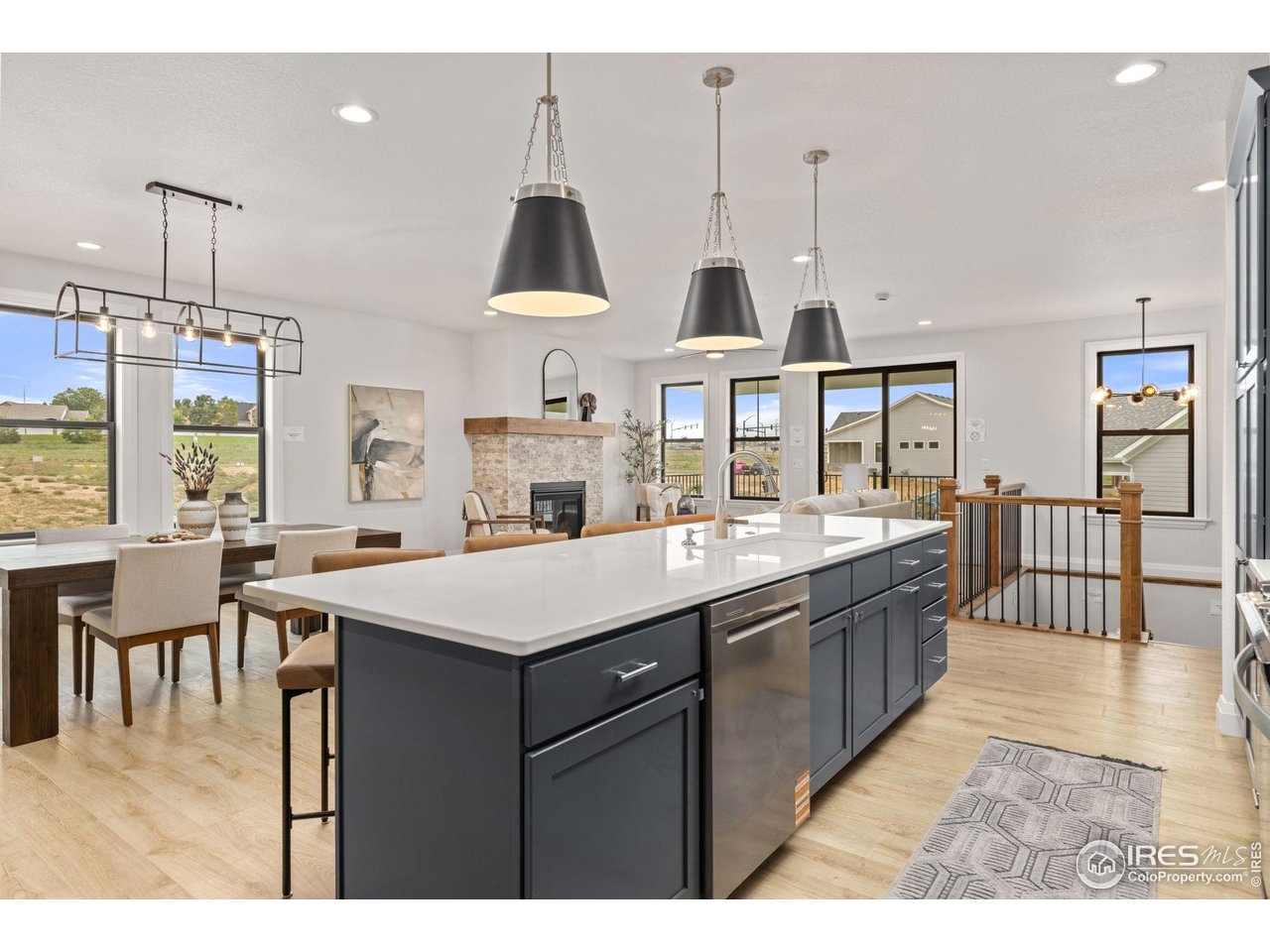 217 57th Avenue Greeley, CO 80634 - Photo 35 of 35 a kitchen with stainless steel appliances kitchen island granite countertop a sink a stove and a wooden floors