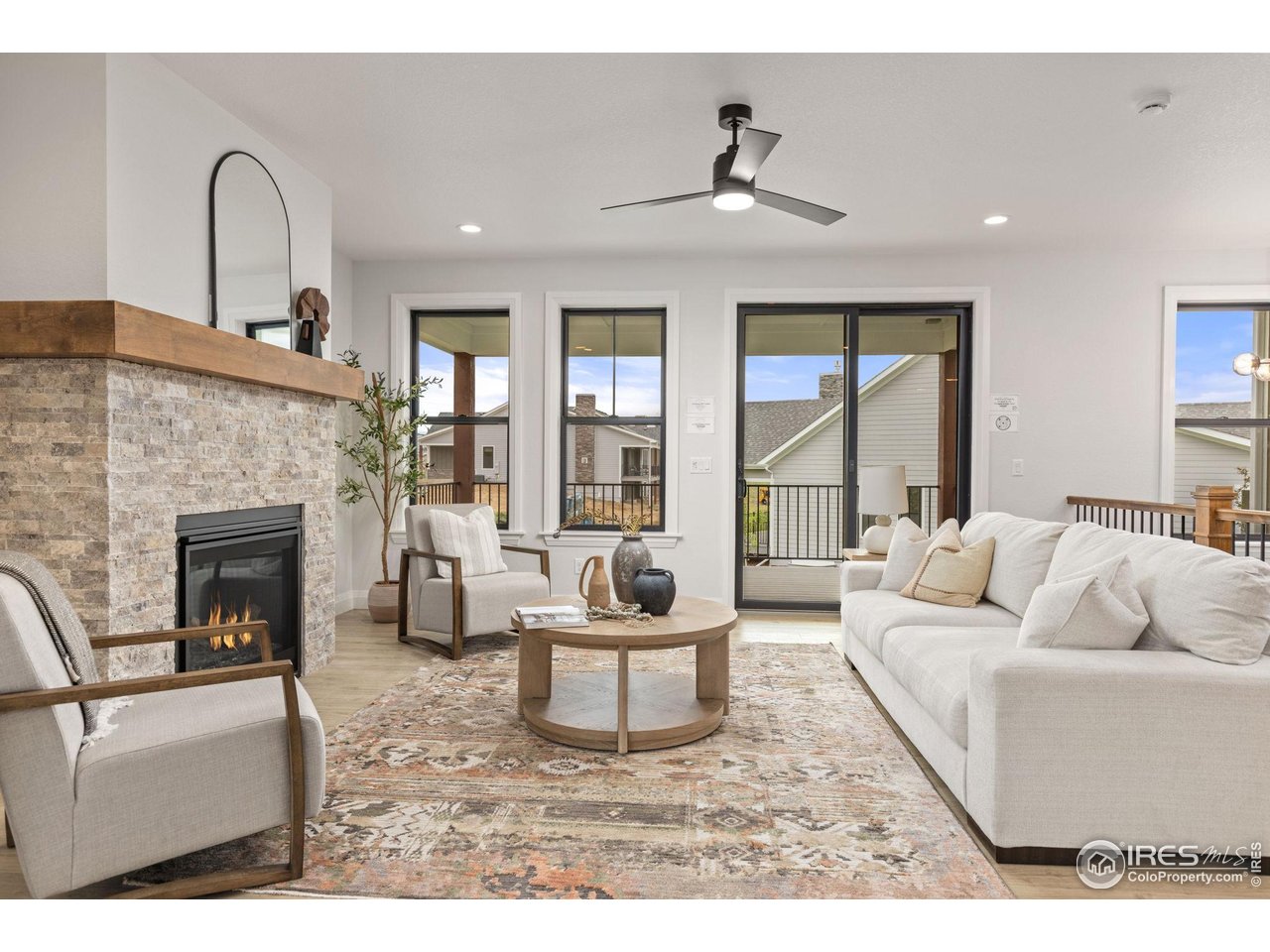217 57th Avenue Greeley, CO 80634 - Photo 15 of 35 a living room with furniture and a fireplace