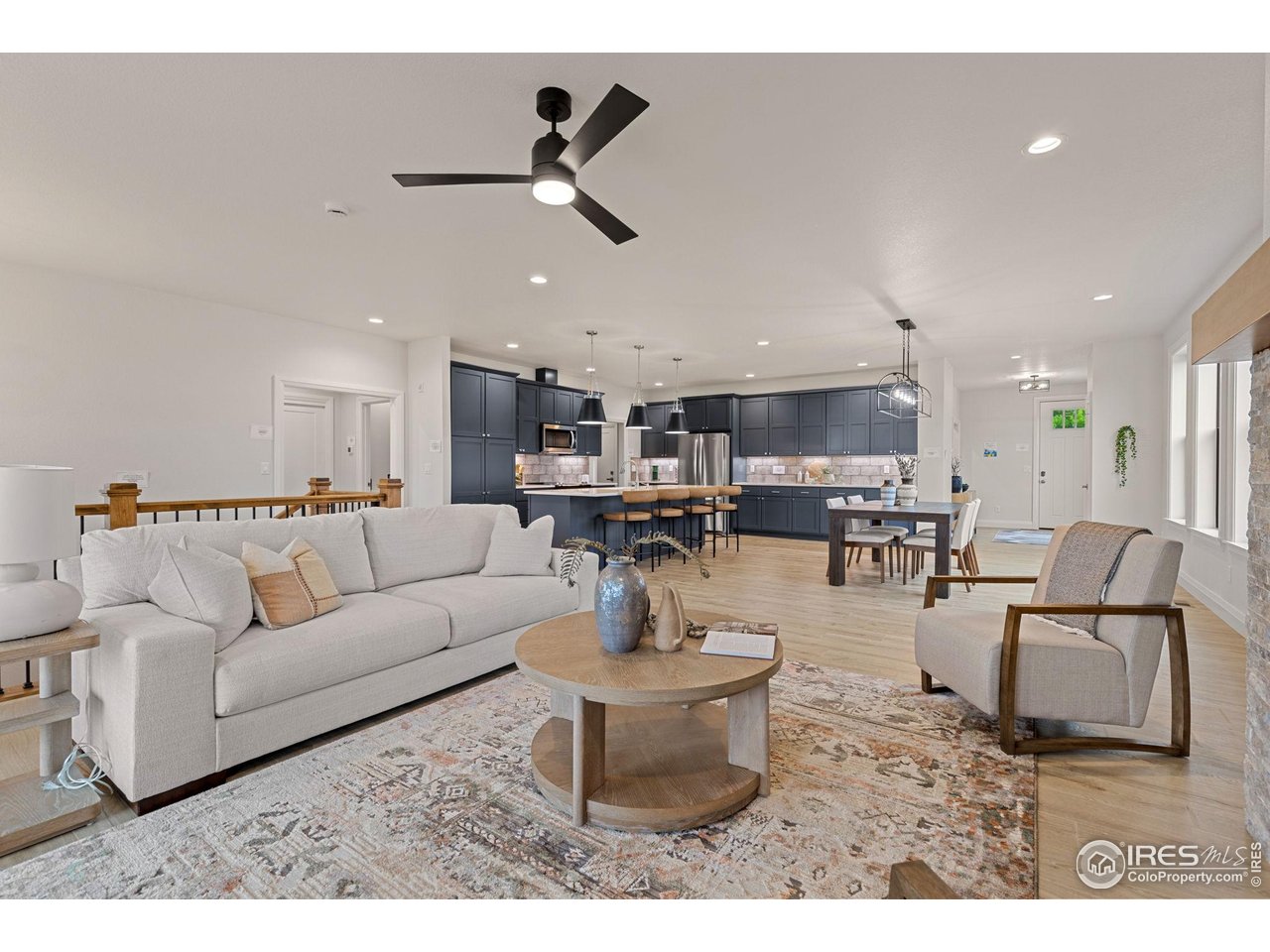 217 57th Avenue Greeley, CO 80634 - Photo 16 of 35 a living room with furniture and kitchen view