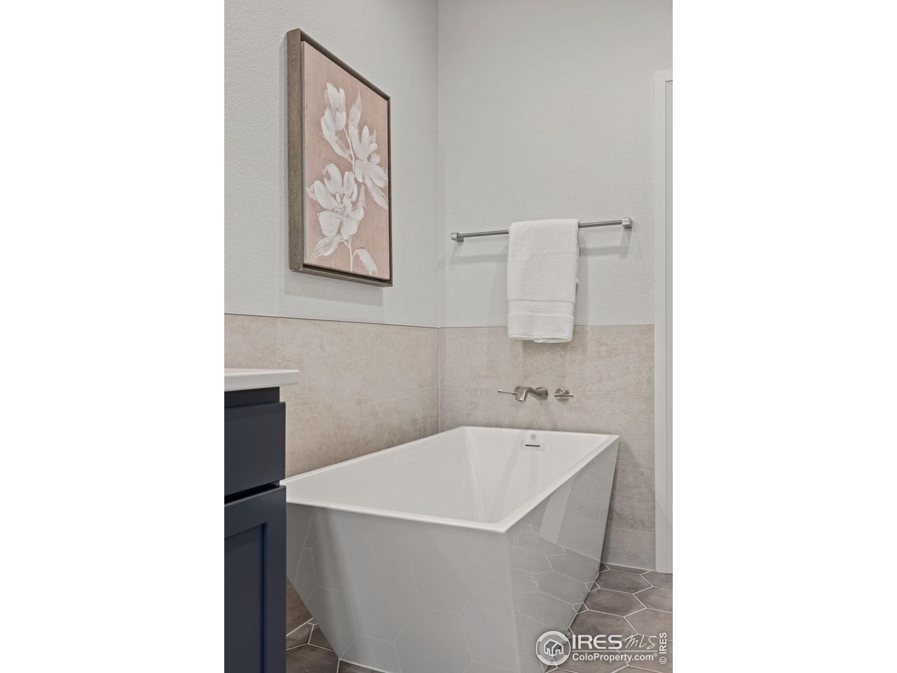 217 57th Avenue Greeley, CO 80634 - Photo 22 of 35 a white bath tub sitting in a bathroom