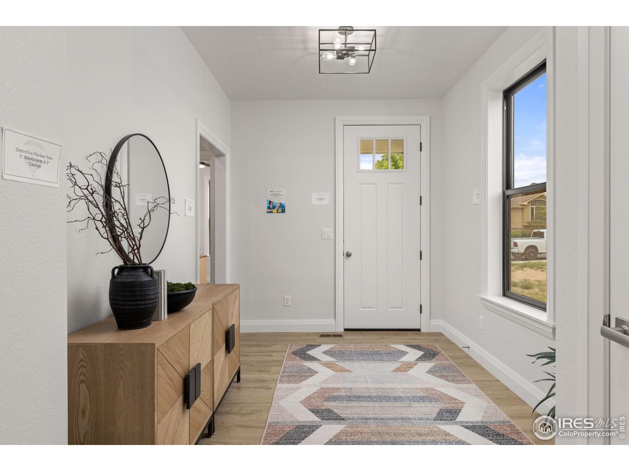 217 57th Avenue Greeley, CO 80634 - Photo 5 of 35 a living room with furniture and a window