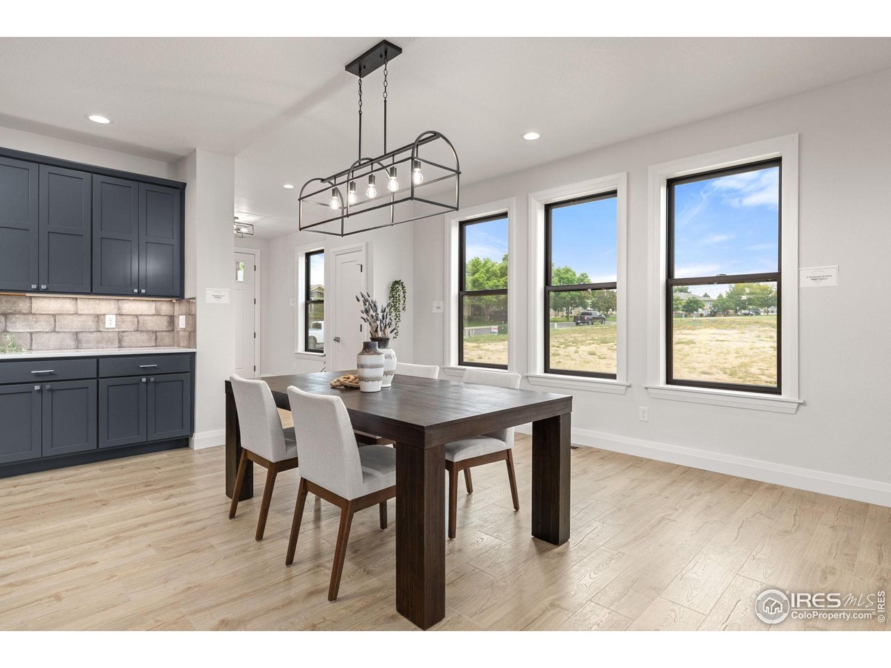 217 57th Avenue Greeley, CO 80634 - Photo 8 of 35 a view of a dining room with furniture window and wooden floor