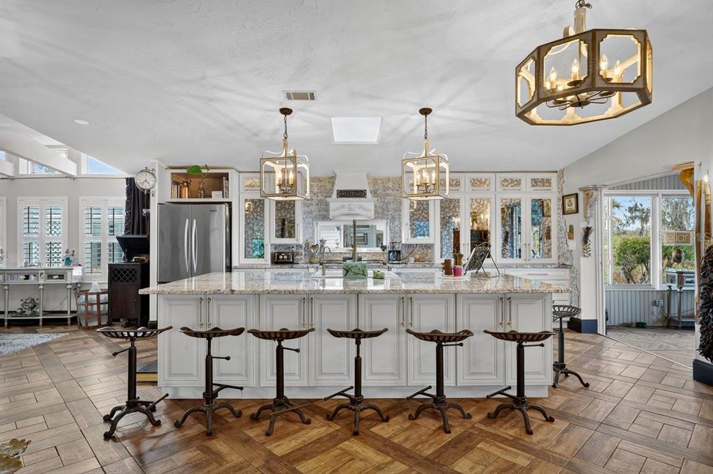 747 Navigators Way Edgewater, FL 32141 - Photo 27 of 73 a large white kitchen with chairs and table