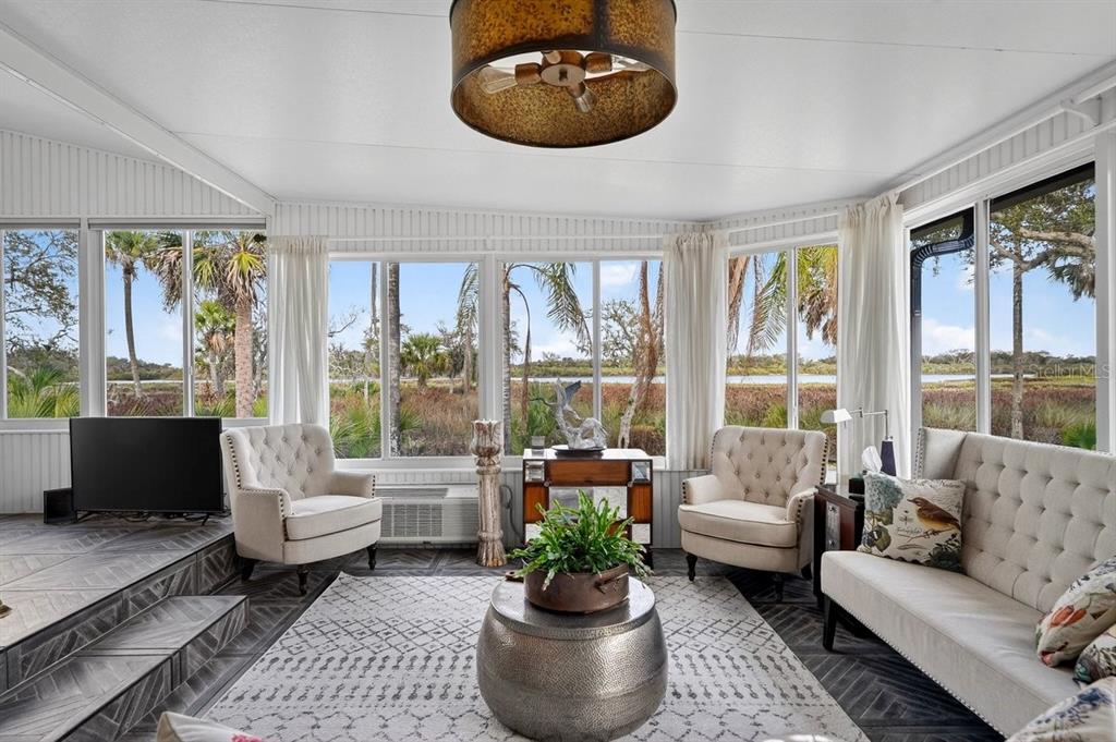 747 Navigators Way Edgewater, FL 32141 - Photo 38 of 73 a living room with furniture and a large window